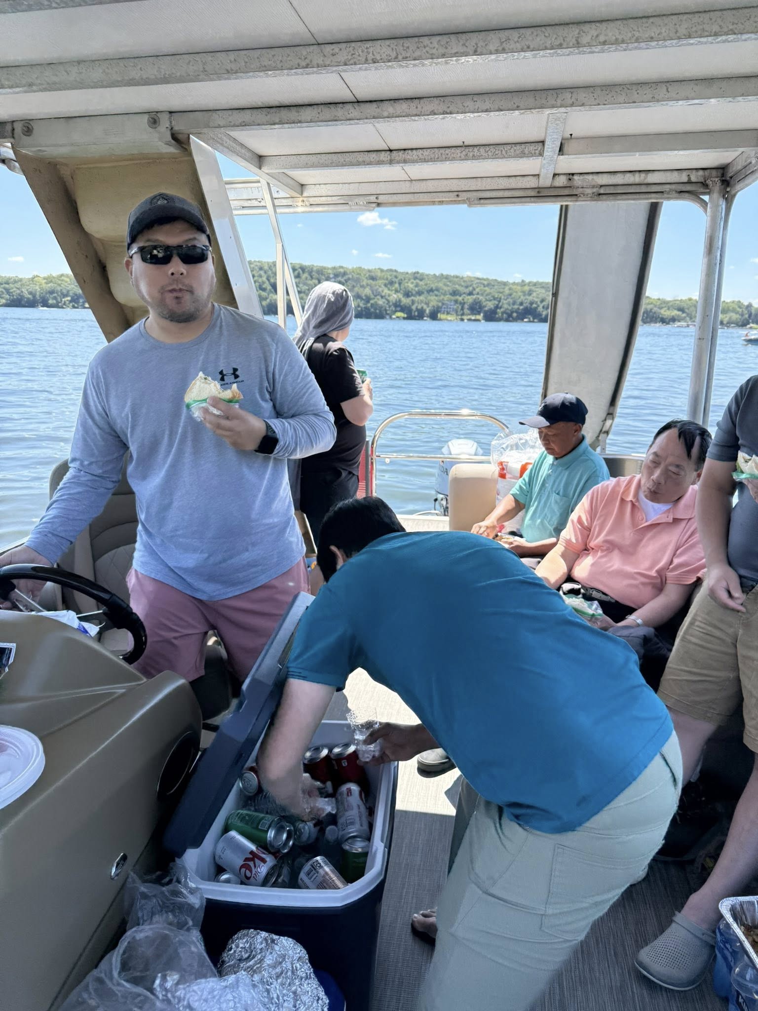 Brother seated on the boat looking out over Green Lake
