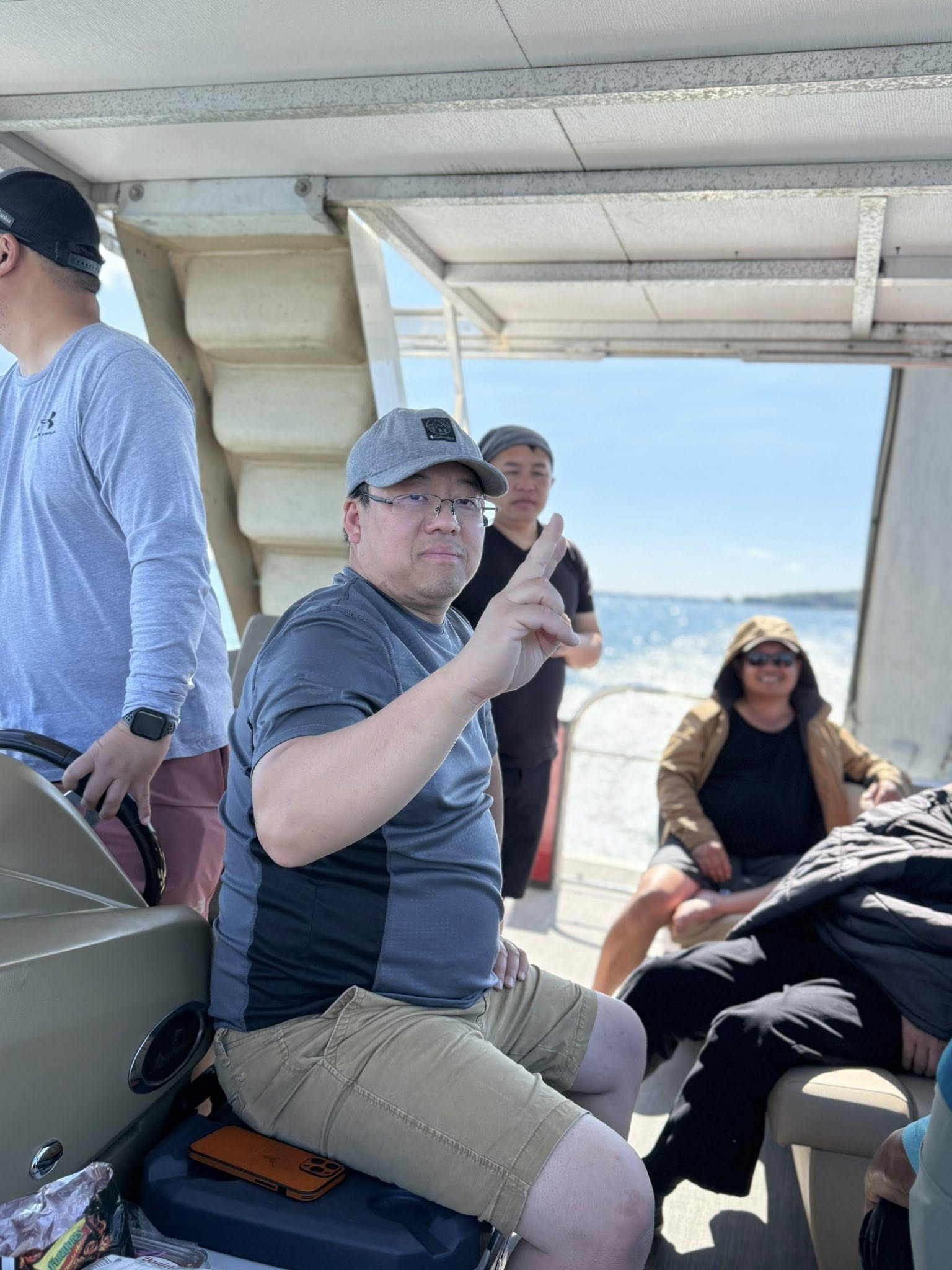 Young man holding fishing gear on the pontoon