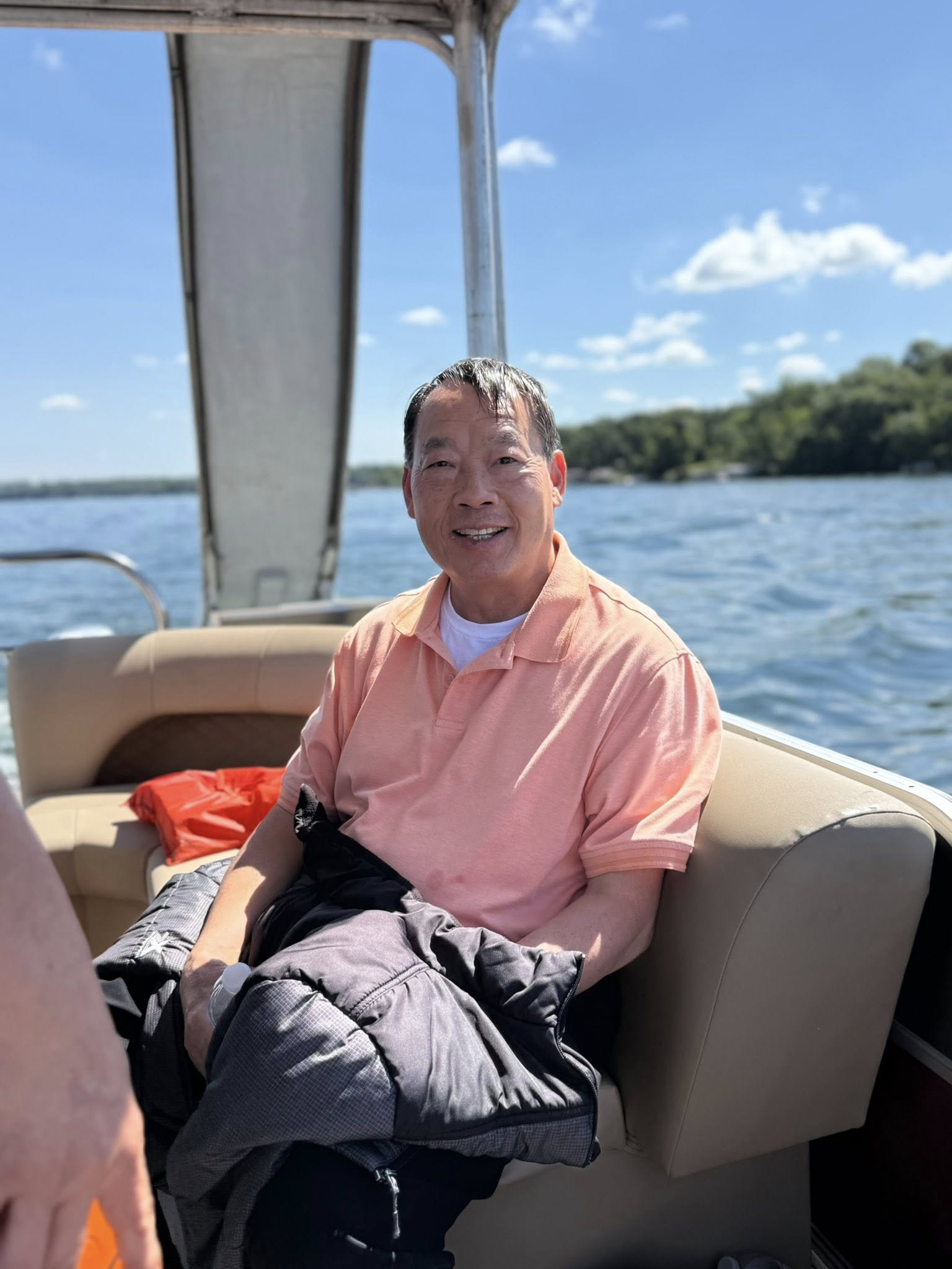 Brother holding a drink on the boat